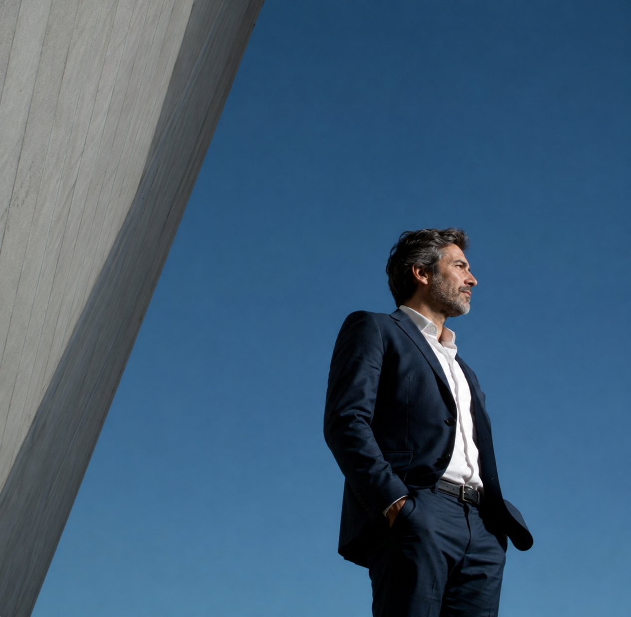 Professional standing against a clear blue sky